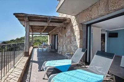 a room with a view of the balcony of a house at Appartement avec vue sur la mer à Olmeto in Olmeto