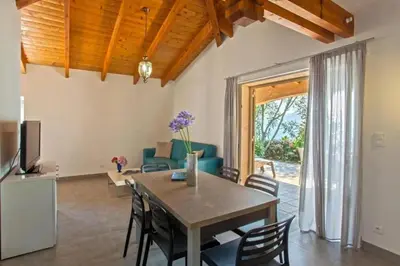 a living room with a table and chairs at Charmante Maison de Vacances à Olmeto avec Piscine in Olmeto
