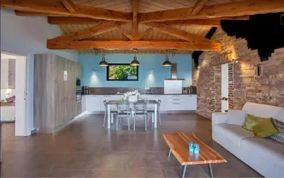 a living room with a couch and a table at Villa moderne avec piscine privée à Olmeto - 95 m² in Olmeto