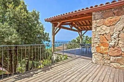 a wooden deck with a wooden pergola at Villa moderne avec piscine privée à Olmeto - 95 m² in Olmeto