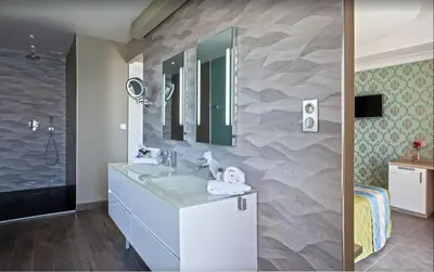 a bathroom with a sink and a mirror at Villa moderne avec piscine privée à Olmeto - 95 m² in Olmeto