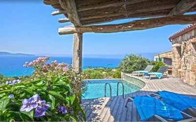 a villa with a swimming pool and the ocean at Villa moderne avec piscine privée à Olmeto - 95 m² in Olmeto