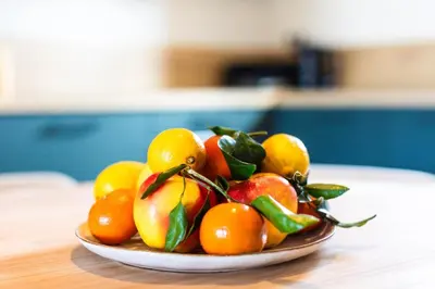 a bowl of fruit on a wooden table at Superbe mini Villa 4 à 6 personnes in Bonifacio