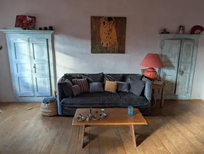 a living room with a couch and a coffee table at Maison de charme in Pioggiola