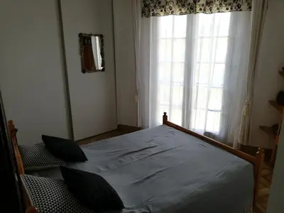 a bedroom with a large bed in front of a window at La Perle du Valinco #Familial#Balcon#Piscine#Mer in Propriano