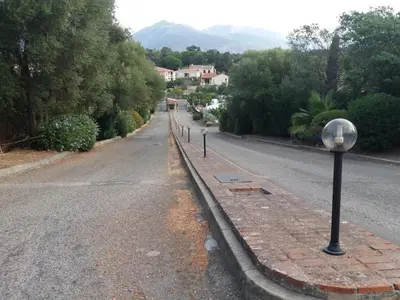 an empty street with a street light on the side of the road at La Perle du Valinco #Familial#Balcon#Piscine#Mer in Propriano
