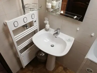 a bathroom with a white sink and a mirror at La Perle du Valinco #Familial#Balcon#Piscine#Mer in Propriano