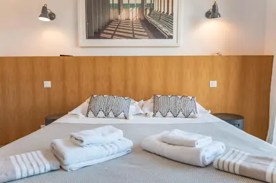 a bedroom with two white towels on a bed at Villa U Pinu Di Pinarellu in Pinarellu