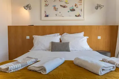 a bed with two towels and two pillows on it at Villa U Pinu Di Pinarellu in Pinarellu