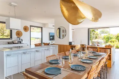 a large dining room with a table and chairs at Villa U Pinu Di Pinarellu in Pinarellu
