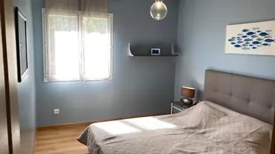 a blue bedroom with a bed and a window at Casa di Luiggi in Venaco