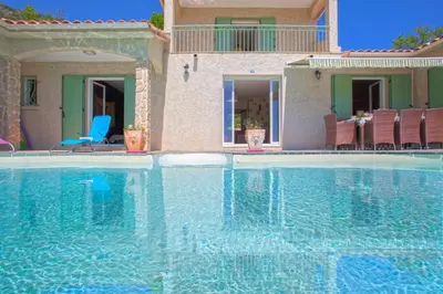 a large swimming pool in front of a house at Casa di Luiggi in Venaco
