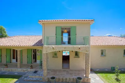 a large house with a balcony on top of it at Casa di Luiggi in Venaco