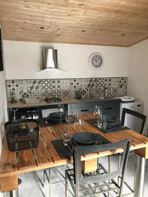 a wooden table with chairs and a dining room at L'Accugliente in Lecci