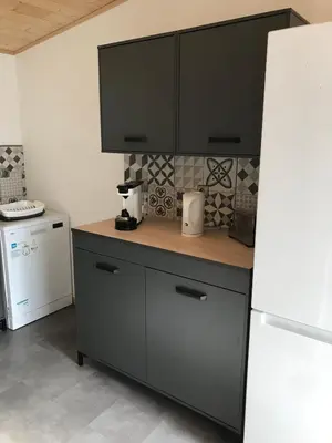 a kitchen with a counter and a white refrigerator at L'Accugliente in Lecci