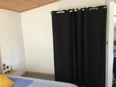 a black curtain in a room with a bed at L'Accugliente in Lecci