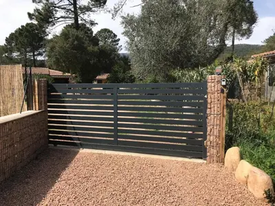 a gate in a fence in a garden at L'Accugliente in Lecci