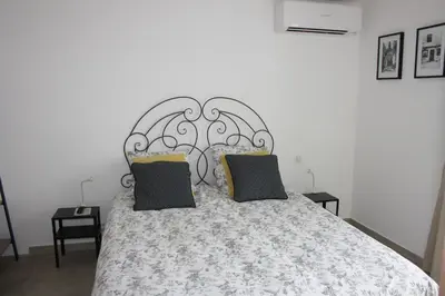 a bedroom with a bed with a metal headboard at chambre face a la mer in Porticcio