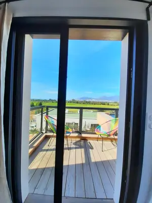 a balcony with two chairs and a view of the ocean at chambre face a la mer in Porticcio