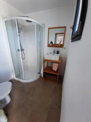 a bathroom with a shower and a toilet and a sink at chambre face a la mer in Porticcio