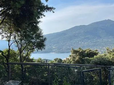 a view of a body of water from a mountain at Vacances de rêve à Propriano Grand appartement avec jardin Vue sur le golfe in Viggianello
