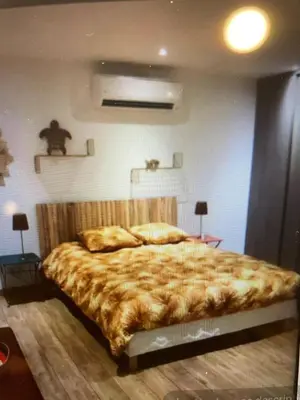a bedroom with a large bed in a room at Vacances de rêve à Propriano Grand appartement avec jardin Vue sur le golfe in Viggianello