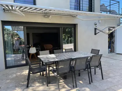 a glass table and chairs on a patio at Vacances de rêve à Propriano Grand appartement avec jardin Vue sur le golfe in Viggianello