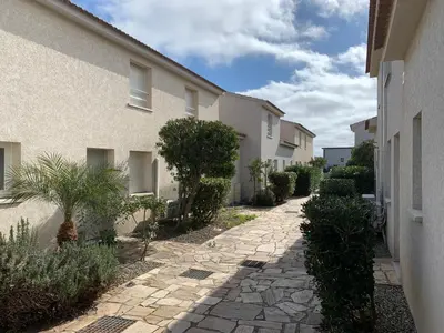 a stone walkway between two buildings with plants at Villa Costa Verde in Cervione