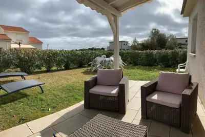 two chairs and a table on a patio at Villa Costa Verde in Cervione