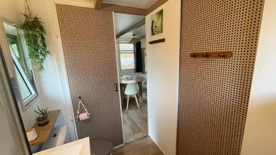 a bathroom with a shower with a toilet and a table at Chalet climatisé en Haute-Corse 500m plage - camping Marina di Sorbo in Sorbo-Ocagnano