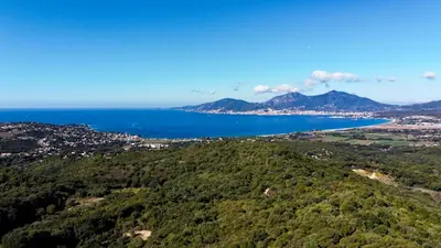 an aerial view of the ocean and mountains at Maison de maître en pierre de 1831 avec vue sur la mer à Porticcio in Porticcio