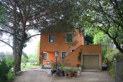 an orange house with a garage in front of it at Kallista 2 in San-Giuliano