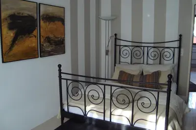 a bedroom with a black bed with two paintings at Kallista 2 in San-Giuliano