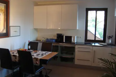 a kitchen with a table with chairs and a tableasteryasteryasteryasteryasteryastery at Kallista 2 in San-Giuliano