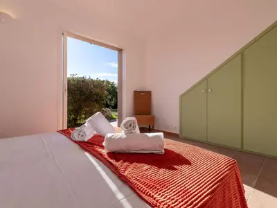 a bedroom with a bed with towels on it at Villa Villa Capicciola by Interhome in Sainte-Lucie de Porto-Vecchio