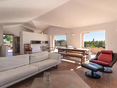 a living room with a couch and a table at Villa Villa Capicciola by Interhome in Sainte-Lucie de Porto-Vecchio