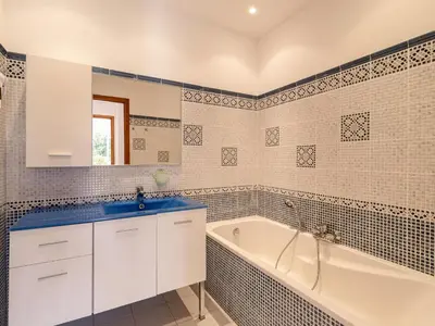 a white bathroom with a tub and a sink at Villa Villa Capicciola by Interhome in Sainte-Lucie de Porto-Vecchio