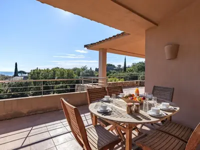 a patio with a table and chairs on a balcony at Villa Villa Capicciola by Interhome in Sainte-Lucie de Porto-Vecchio
