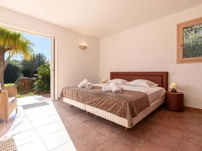 a bedroom with a bed and a large window at Villa Villa Capicciola by Interhome in Sainte-Lucie de Porto-Vecchio