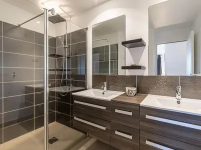 a bathroom with two sinks and a glass shower at Holiday Home Casa Caminu by Interhome in Porto-Vecchio