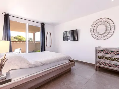 a bedroom with a large bed and a window at Holiday Home Casa Caminu by Interhome in Porto-Vecchio