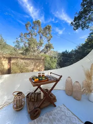 a table with a tray of food on top of a tent at Bulle du Fangu in Galeria