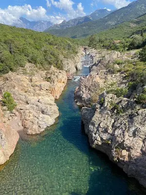 an aerial view of a river between some rocks at Bulle du Fangu in Galeria