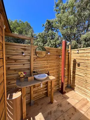 a bathroom with a sink on a wooden fence at Bulle du Fangu in Galeria
