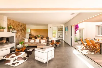 a living room with white furniture and a table at Ecrin de Pinarello in Pinarellu