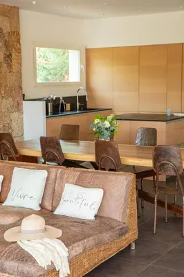 a living room with a couch and a table at Ecrin de Pinarello in Pinarellu