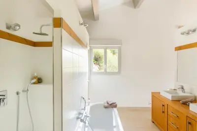a bathroom with a tub and a sink at Ecrin de Pinarello in Pinarellu