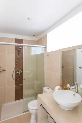 a bathroom with a sink and a toilet and a shower at Ecrin de Pinarello in Pinarellu