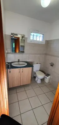 a bathroom with a sink and a toilet and a mirror at Studio 30 m2 climatisé calme in Eccica-Suarella