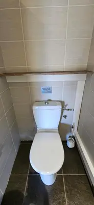 a bathroom with a white toilet in a stall at T2 Dolce & Vita C3 vue mer et piscine in Propriano
